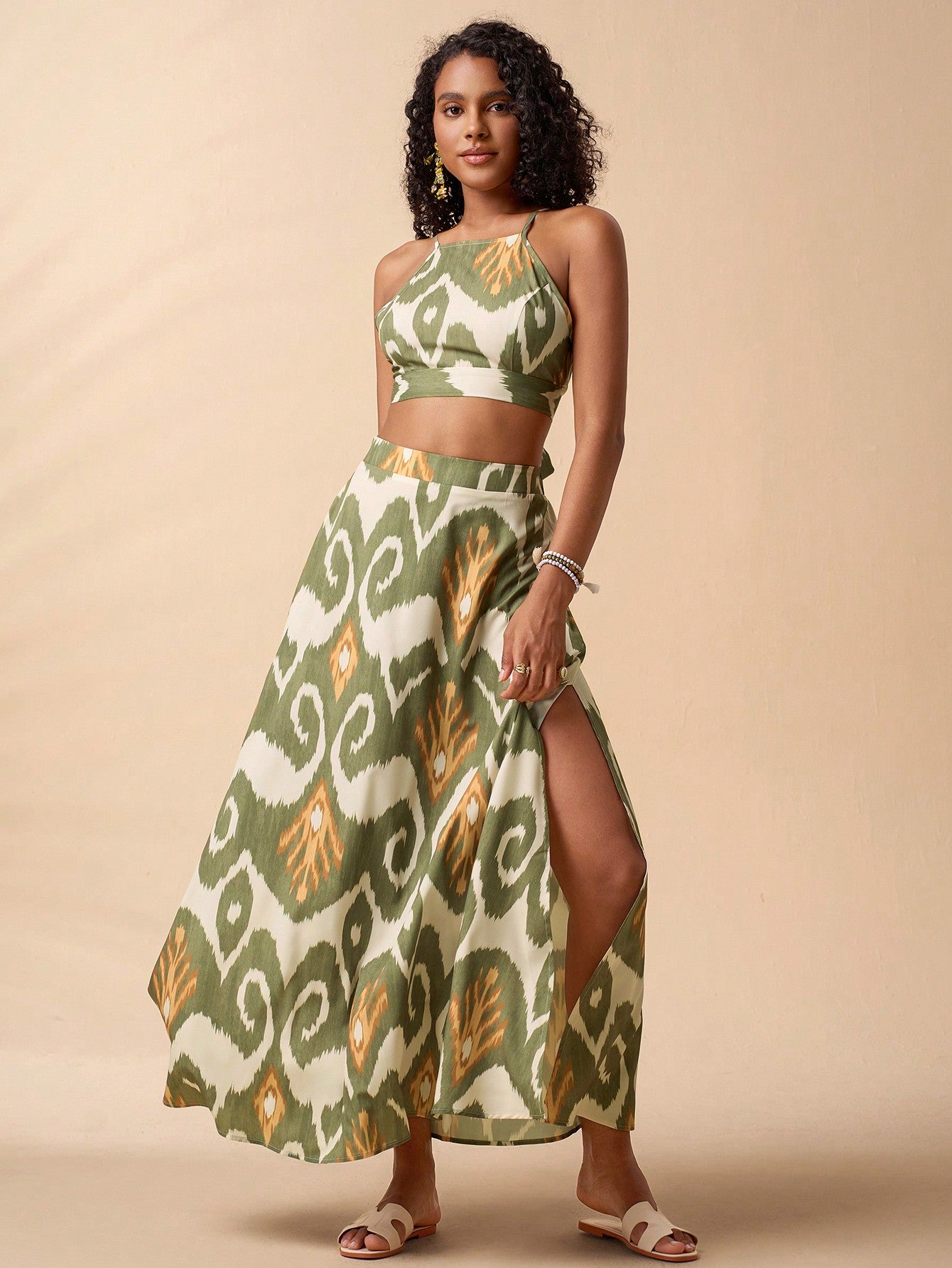 Stylish 3Sixty5 bold print two-piece outfit featuring a crop top and high-slit maxi skirt