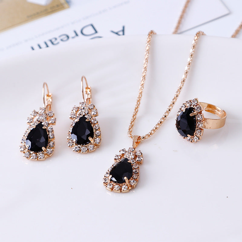 Rhinestone jewelry set featuring a necklace, earrings, and a ring with elegant black stones