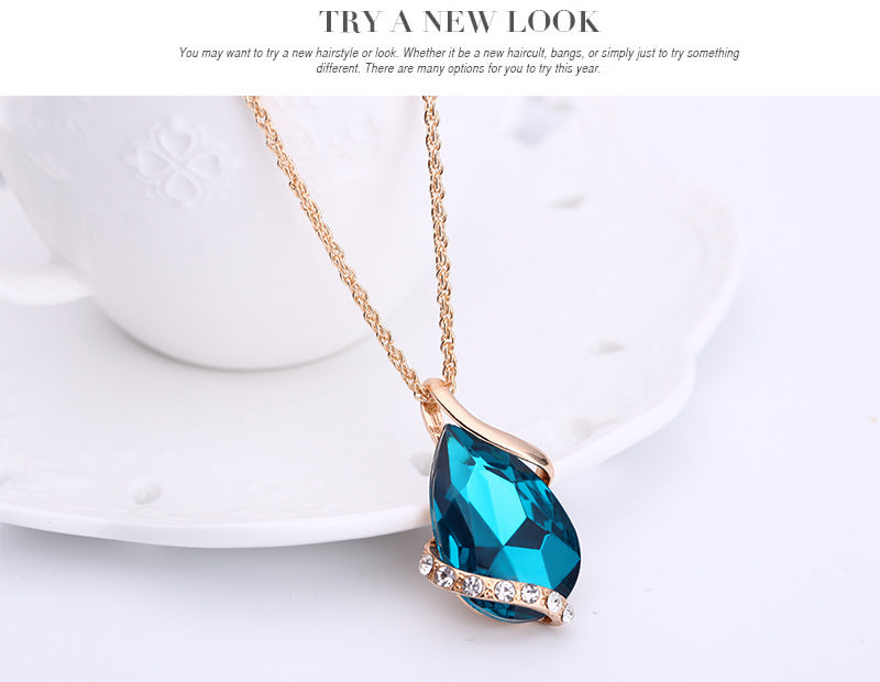 Elegant royal dewdrop jewelry set featuring a stunning blue pendant and gold accents