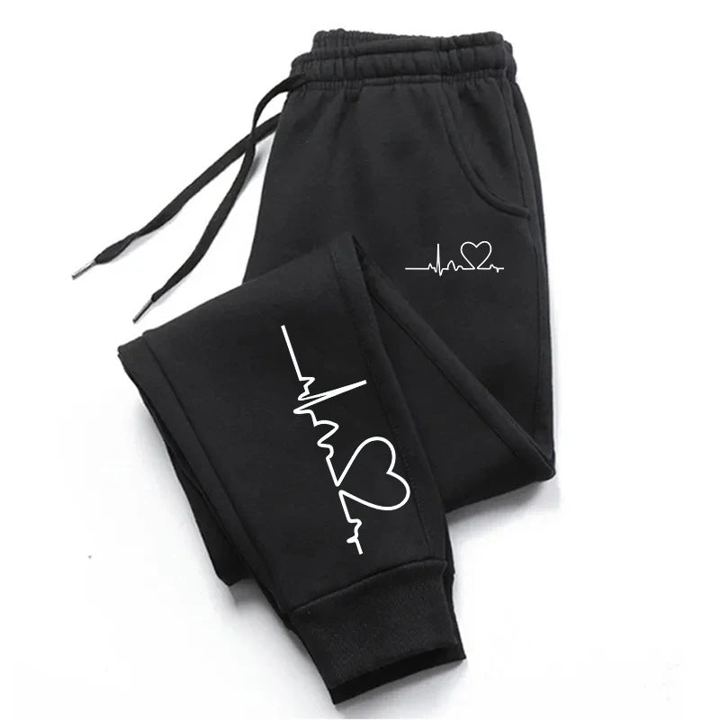 Stylish 3Sixty5 everyday glam track pants in black with heart and heartbeat graphic design