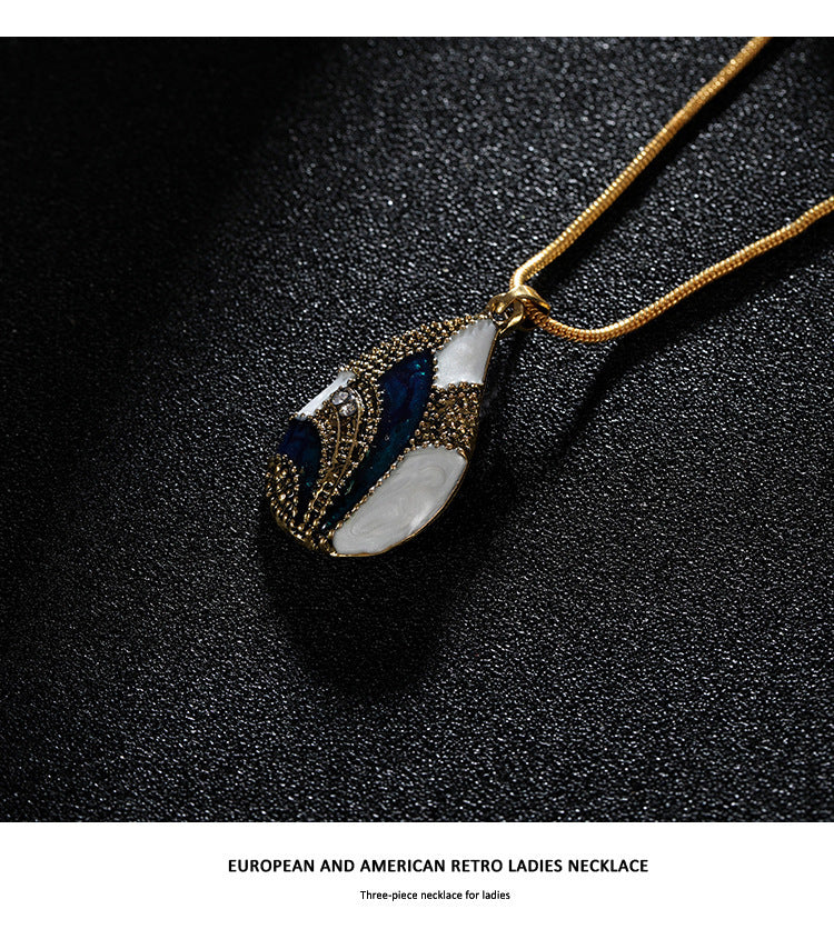 Ocean Mist Drop Jewelry Set featuring a gold necklace with a teardrop pendant in blue and pearl accents