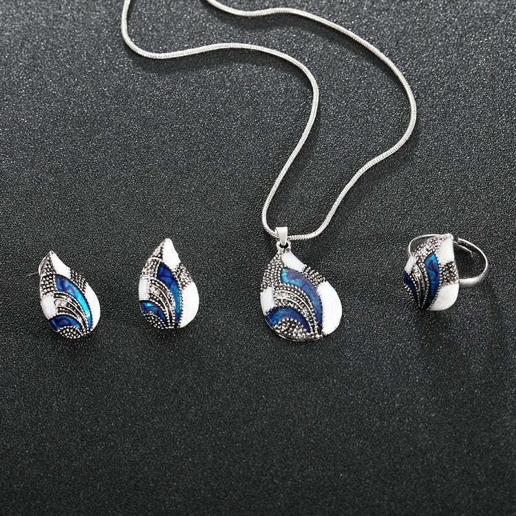 Ocean Mist Drop Jewelry Set featuring elegant drop earrings, a pendant, and a ring with blue details