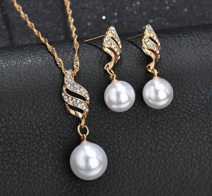 Elegant pearl jewelry gift set featuring a necklace and earrings with gold accents and sparkling details