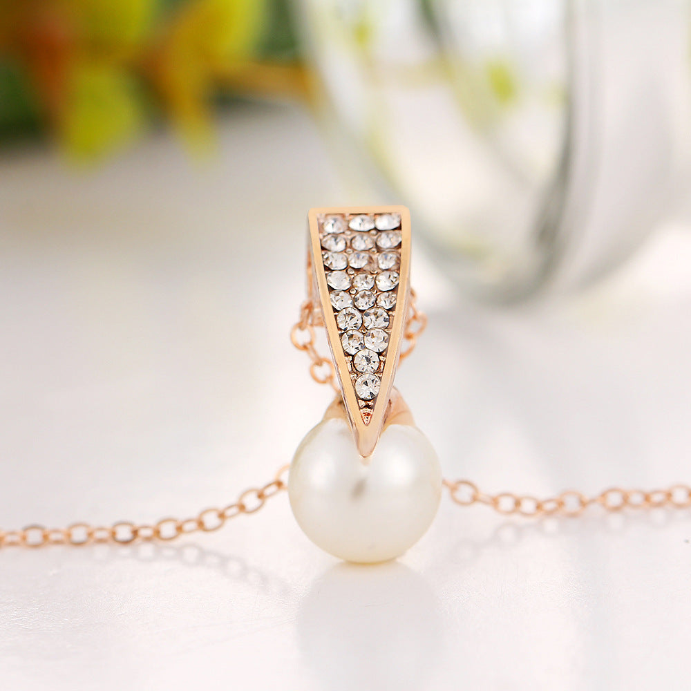 Elegant pearl luxe duo jewelry set featuring a rose gold pendant with sparkling stones and a pearl detail