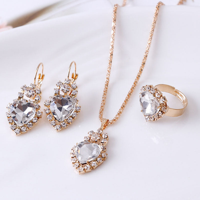 Stylish 3Sixty5 rhinestone jewelry set featuring earrings, necklace, and ring with heart-shaped designs