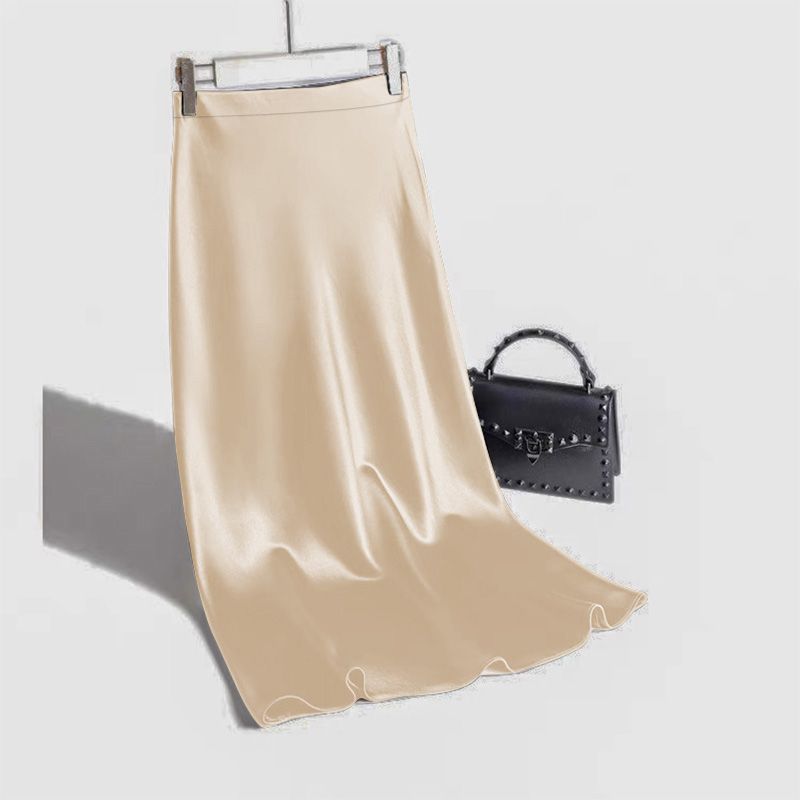 Elegant beige satin straight skirt paired with a stylish handbag for a chic look