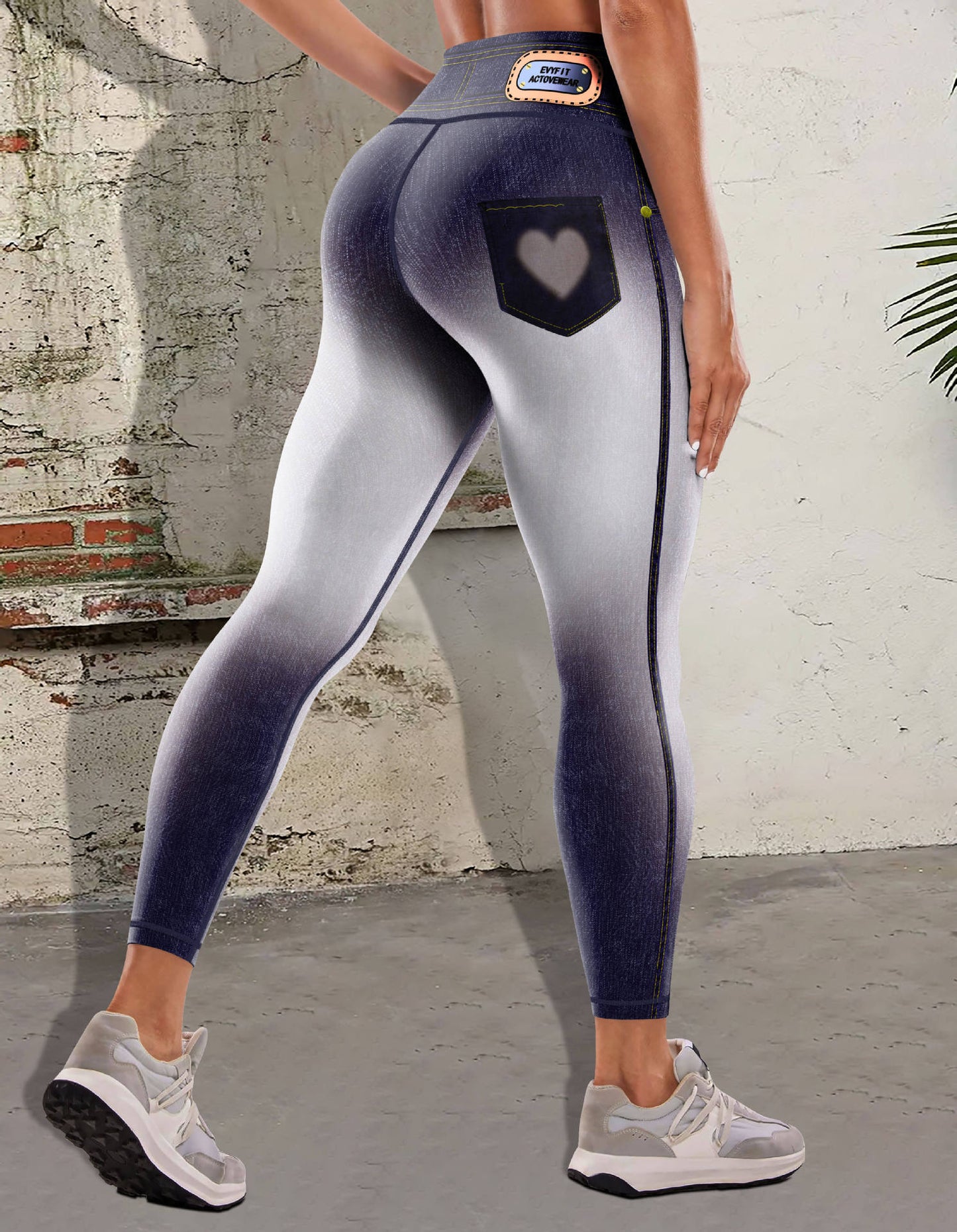 Stylish 3Sixty5 women's denim yoga pants with a heart pocket design and fitted silhouette